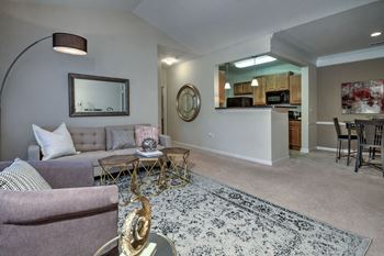 Living room and kitchen open floorplan at Abberly Woods Apartment Homes by HHHunt, North Carolina